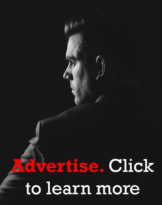 A photo of a gentleman in a black suit against a black background for an advertisement for Houghton & Mackay