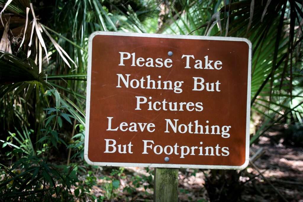 A sign states, "Please take nothing but Pictures, leave nothing but Footprints" for Florida Guidebook in an article on Houghton & Mackay by Janine White