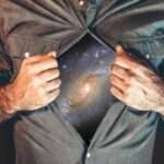 Photo of a man opening his shirt to reveal the Universe for an article about Manifesting by Hannah Burns for Houghton & Mackay