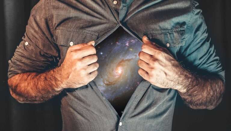 Photo of a man opening his shirt to reveal the Universe for an article about Manifesting by Hannah Burns for Houghton & Mackay