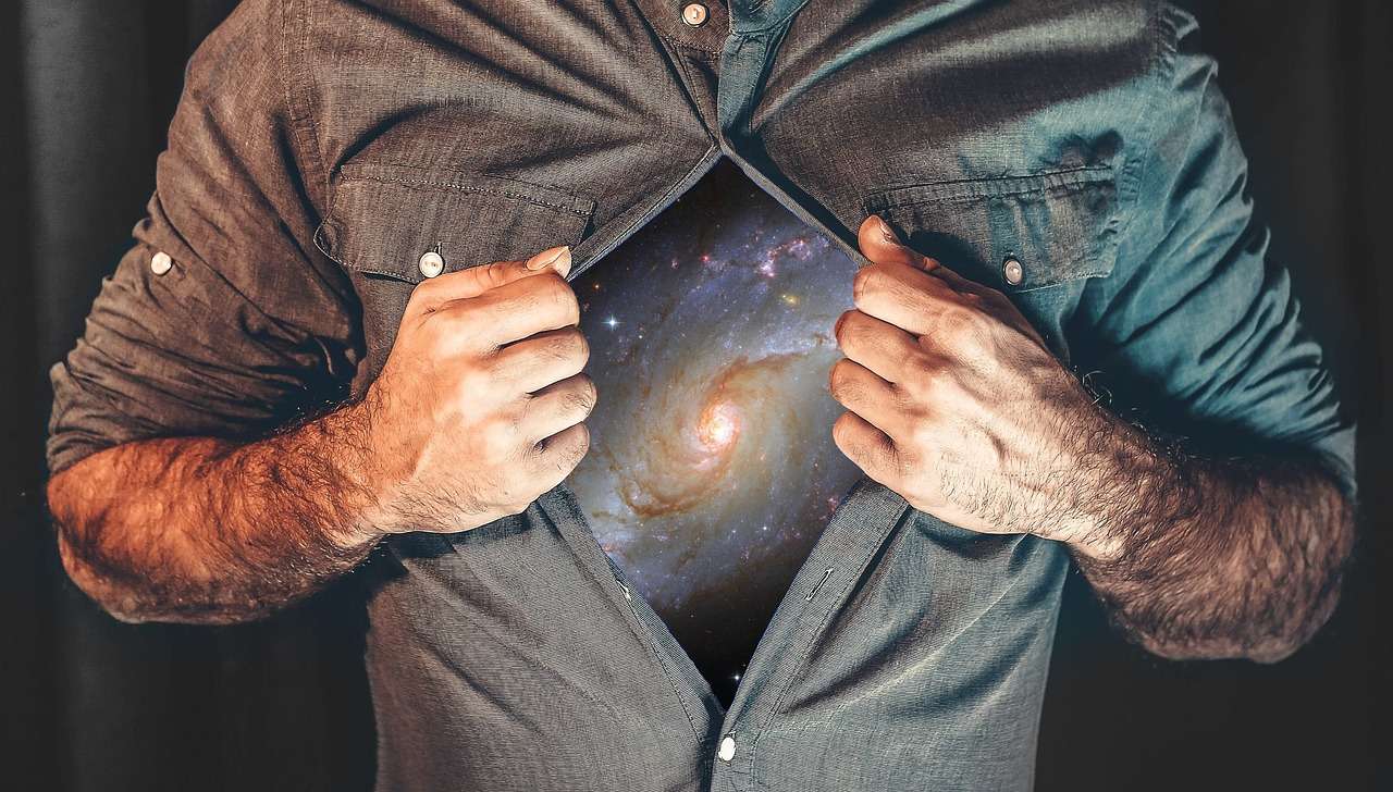 Photo of a man opening his shirt to reveal the Universe for an article about Manifesting by Hannah Burns for Houghton & Mackay